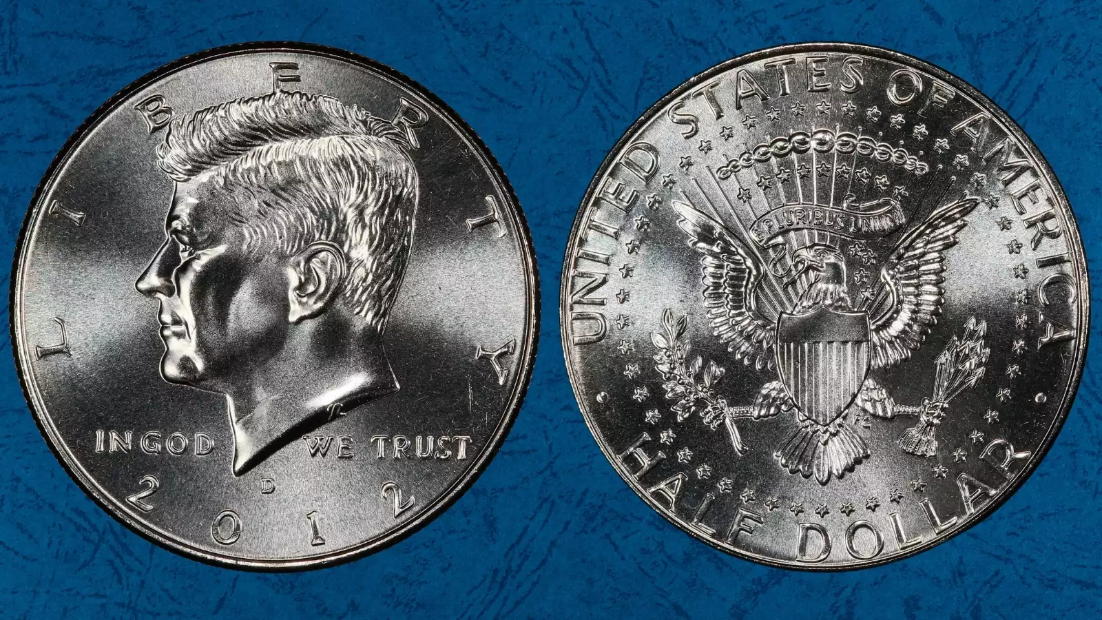 Grading strip showing 2012 Kennedy half dollars in four condition tiers from worn/circulated through gem uncirculated for comparison
