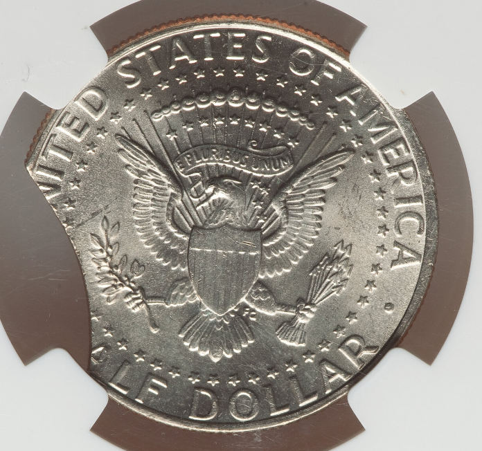 2012 Kennedy half dollar clipped planchet error showing a curved section missing from the coin edge