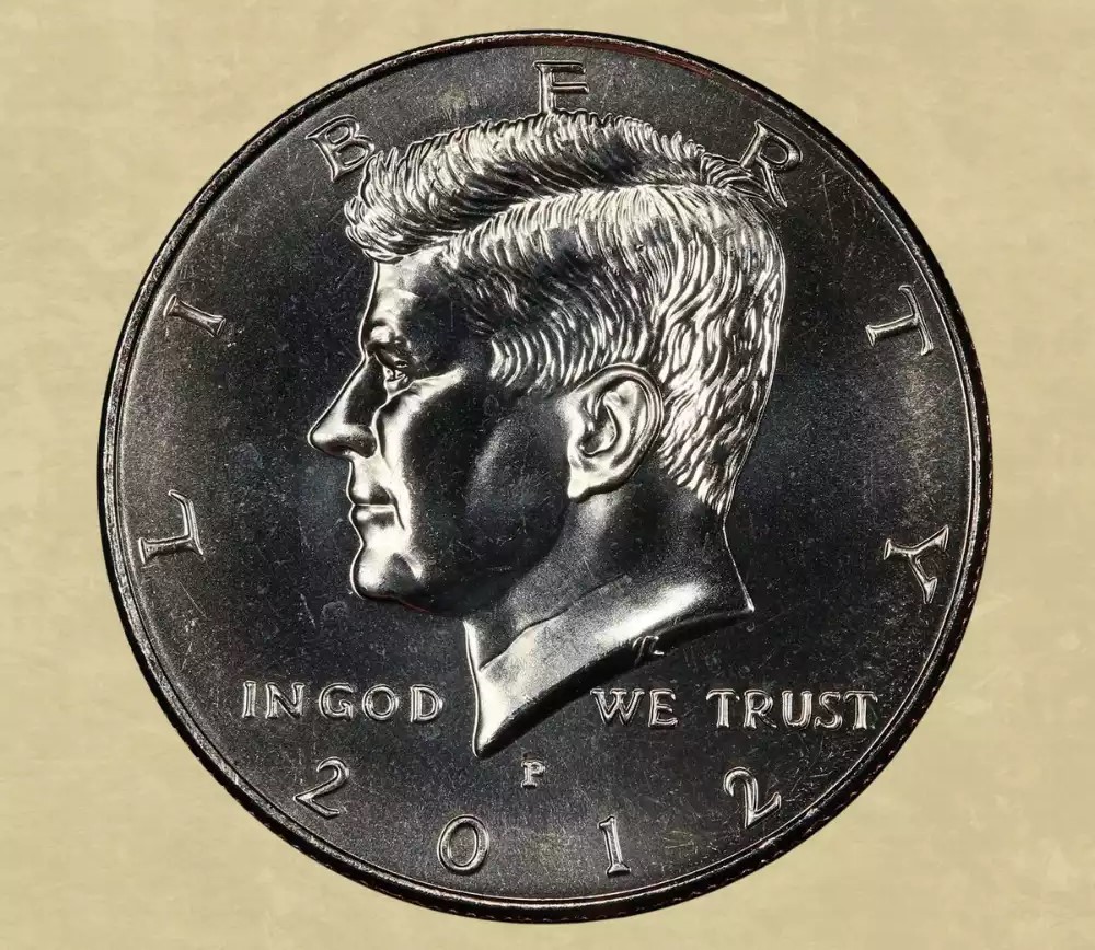 2012 Kennedy half dollar doubled die obverse error showing doubling on LIBERTY lettering visible under magnification
