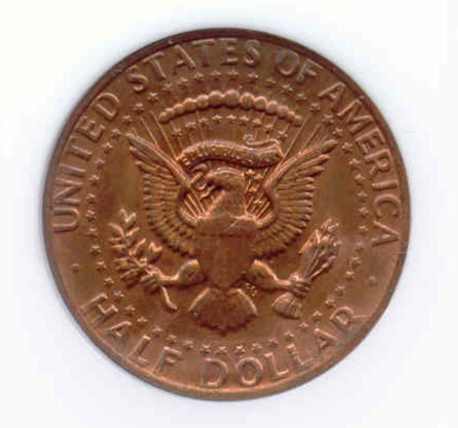 2012 Kennedy half dollar missing clad layer error showing one side with exposed copper-red surface instead of the normal silver-gray clad appearance